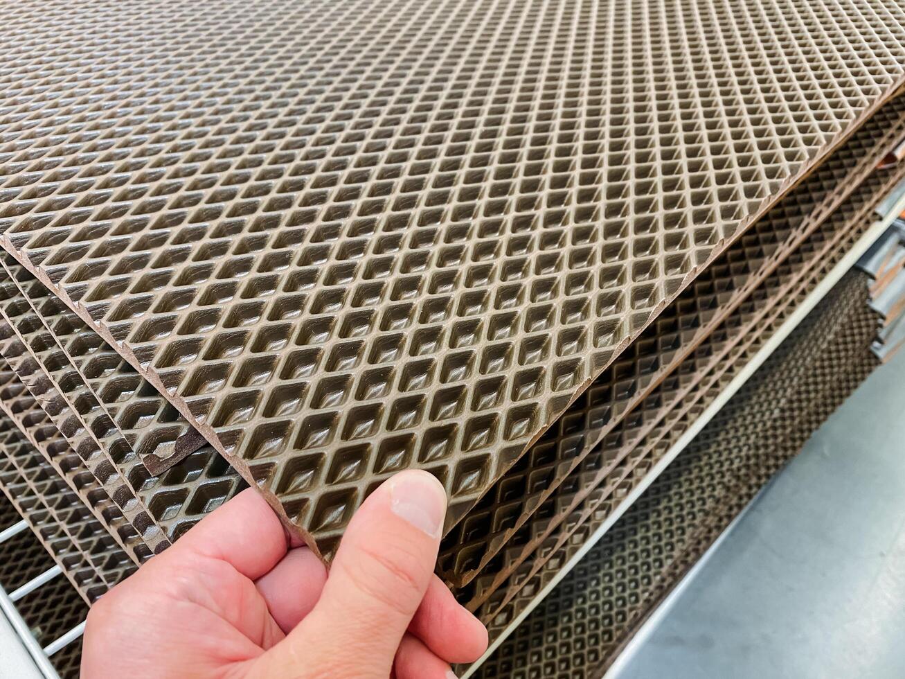 A person is firmly holding a piece of wafer paper in their hand, showcasing its delicate texture and structure while demonstrating an interesting material in a handson manner photo