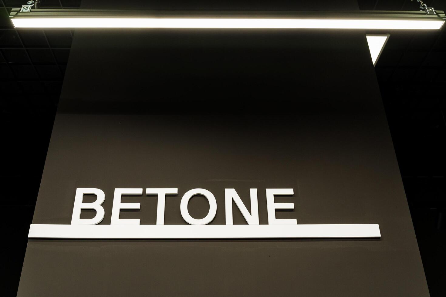 A rectangular sign with a unique font reading betone serves as a branding communication device for events. Its a multimedia display gadget creating a strong brand impact photo