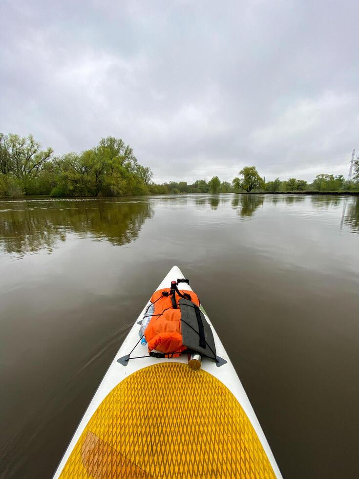 Witness a peaceful sight as a kayak smoothly glides on a peaceful lake surrounded by a picturesque forest, showcasing the beauty of nature and the tranquility of the environment photo
