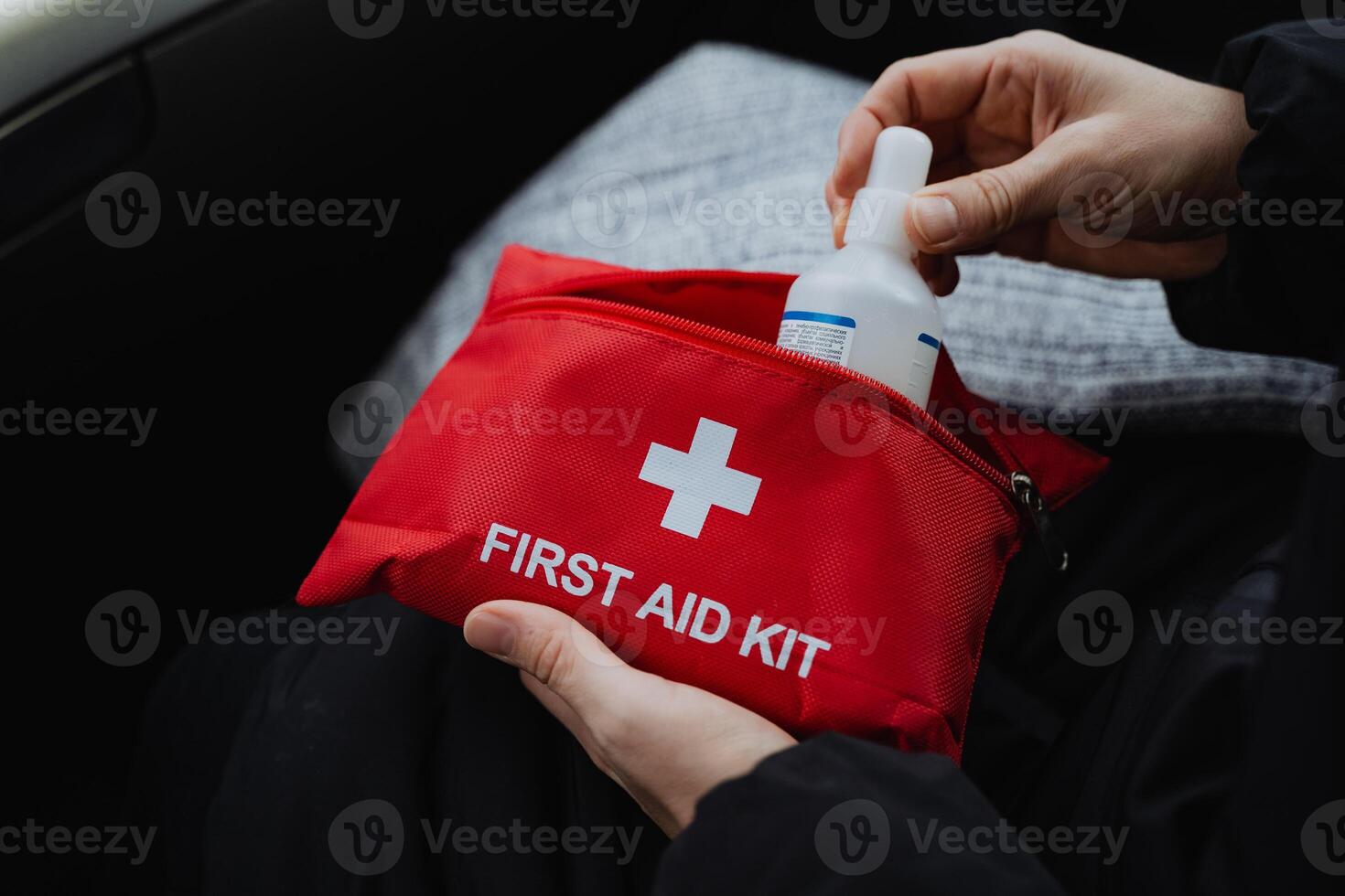 A person stands confidently while holding a first aid kit, demonstrating their calm assurance and readiness to assist in emergencies, prioritizing the safety and wellbeing of those in need photo