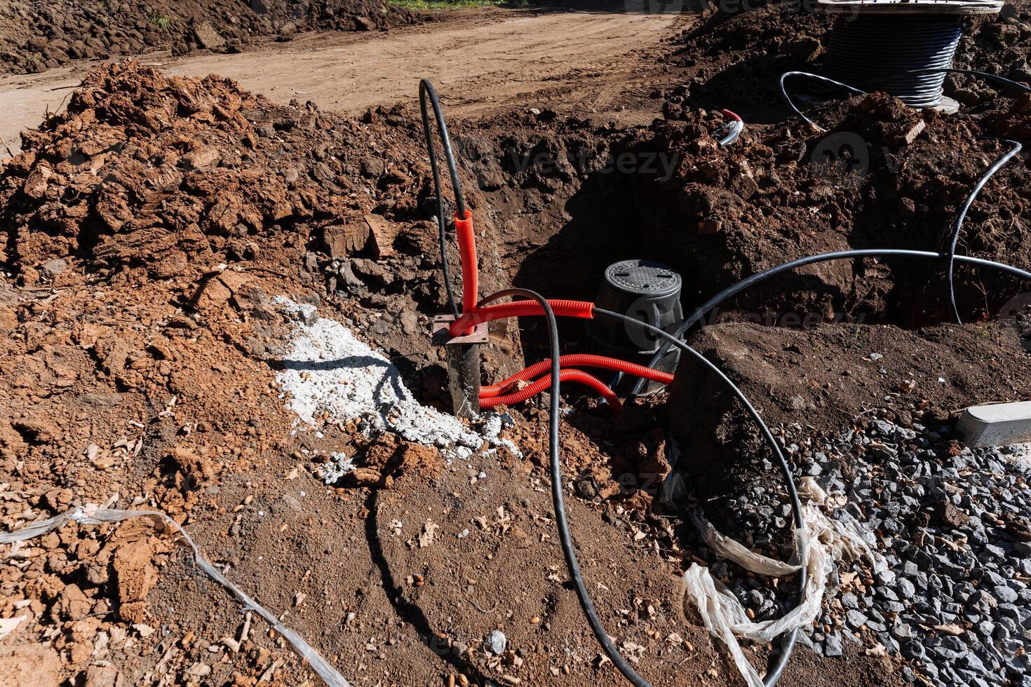 Construction site featuring extensive underground pipes and various electrical connections necessary for modern infrastructure installations photo