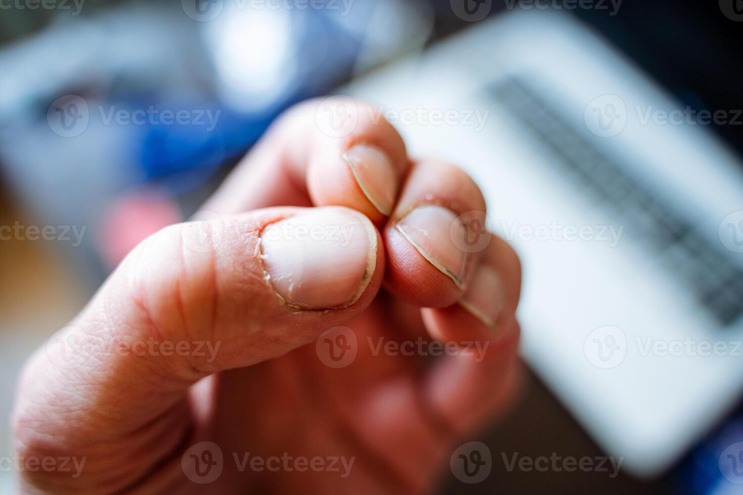 A close up of a person s nails with a laptop in the background photo