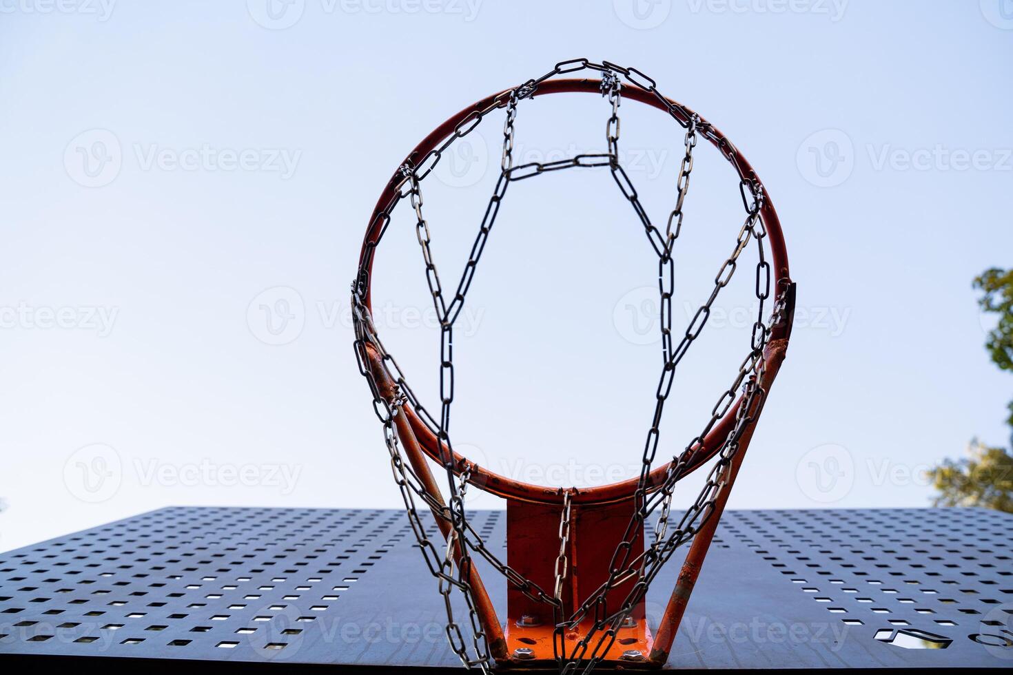 Gazing Upwards at a Tall Basketball Hoop Beneath a Bright and Clear Blue Sky on an Absolutely Beautiful Day Outdoors photo