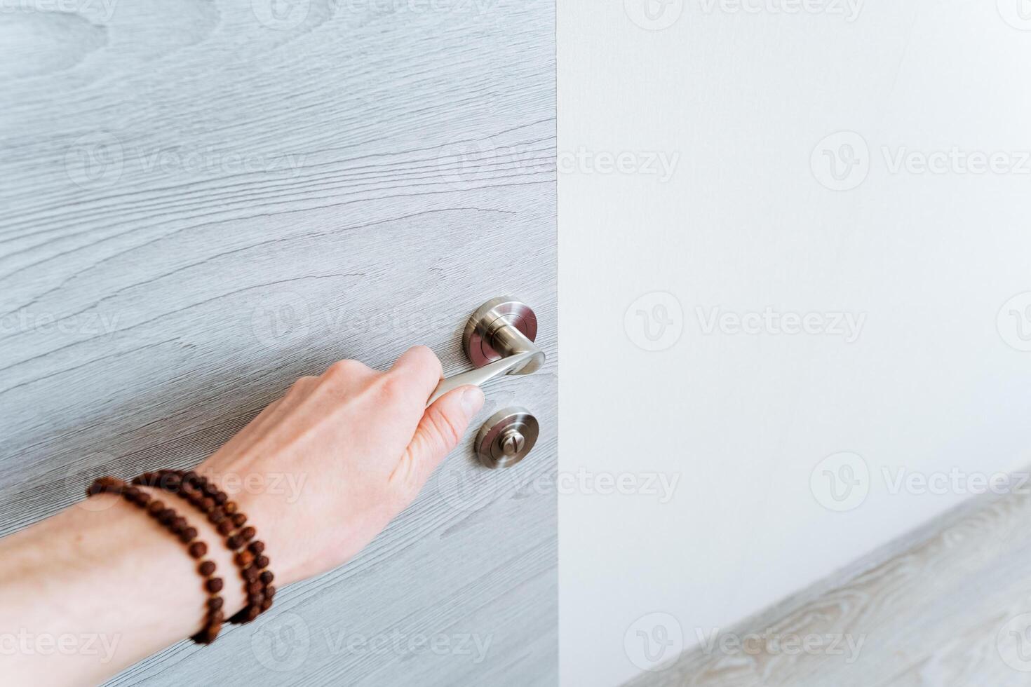 The woman is using her hand to open the door with a gesture photo