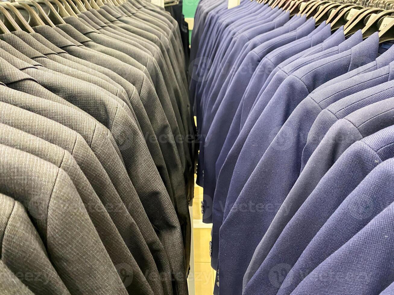 This diverse rack features a variety of dark sweaters, ideal for creating retail displays that effectively attract shoppers and enhance their wardrobe selections photo