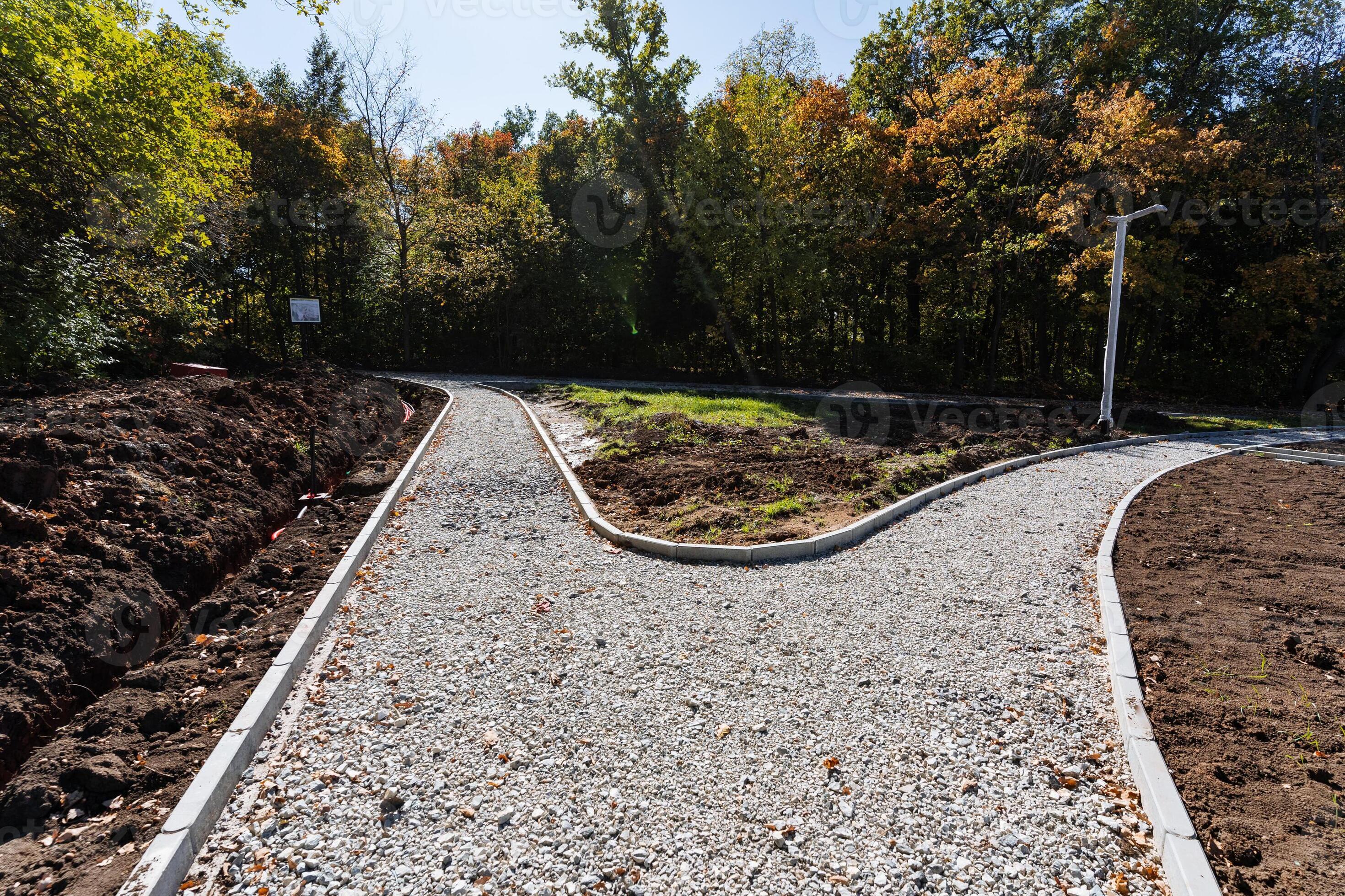 A beautifully curved pathway is currently under construction, framed by ...