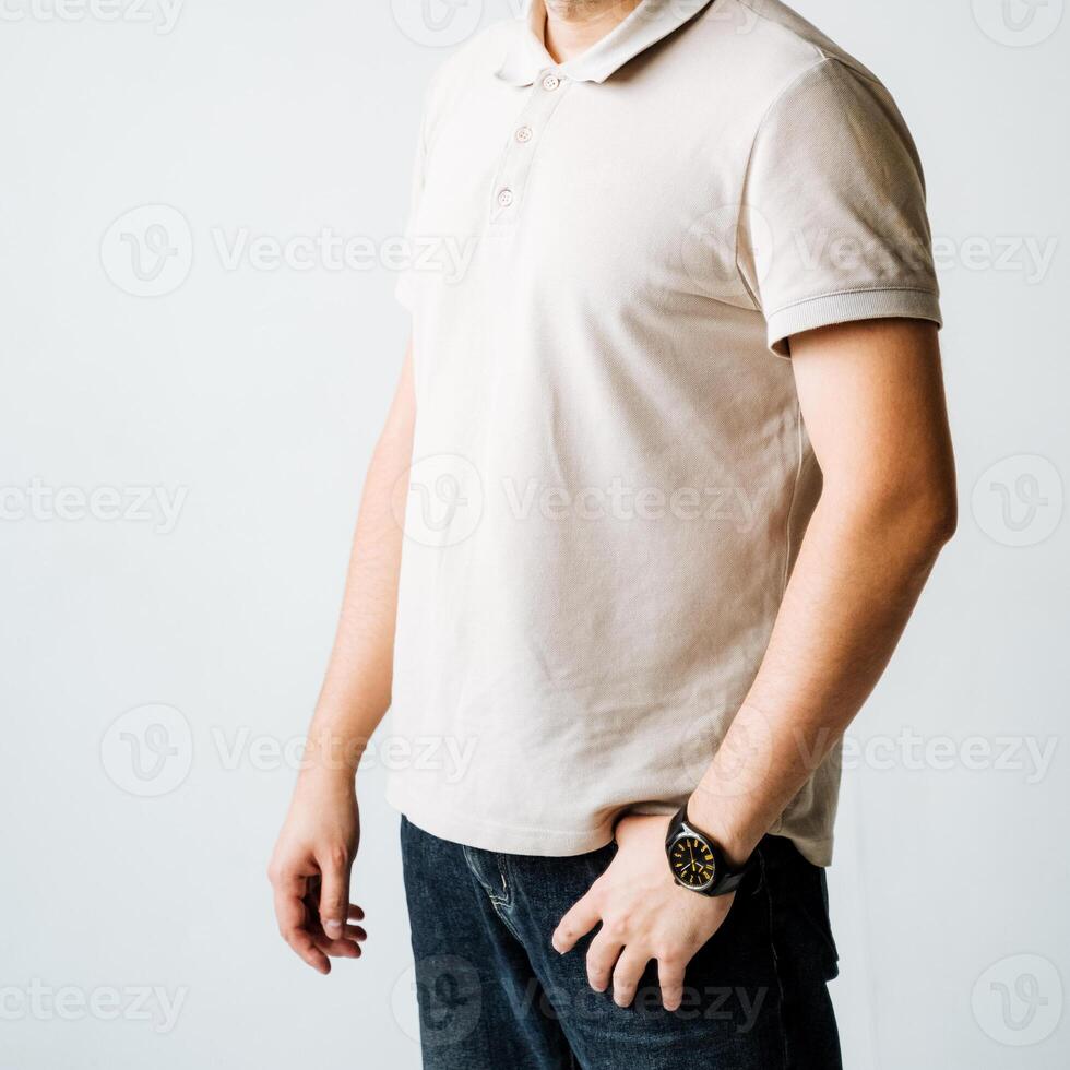 A fashionable man is elegantly dressed in a trendy white polo shirt paired with a sleek, modern watch, creating a chic and casual appearance that is perfect for a variety of occasions photo