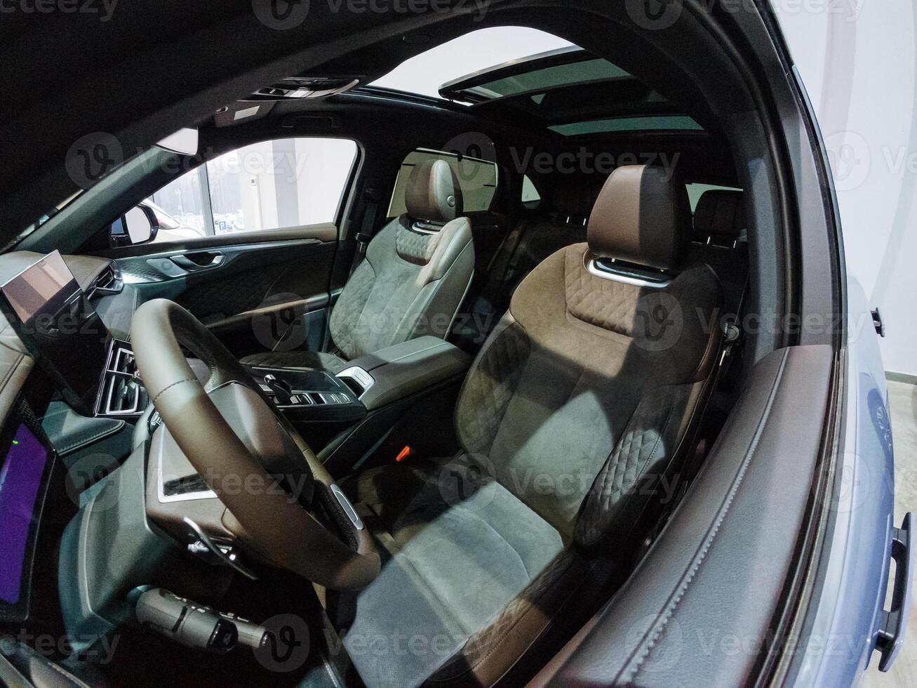 The inside of a car with the sunroof open photo