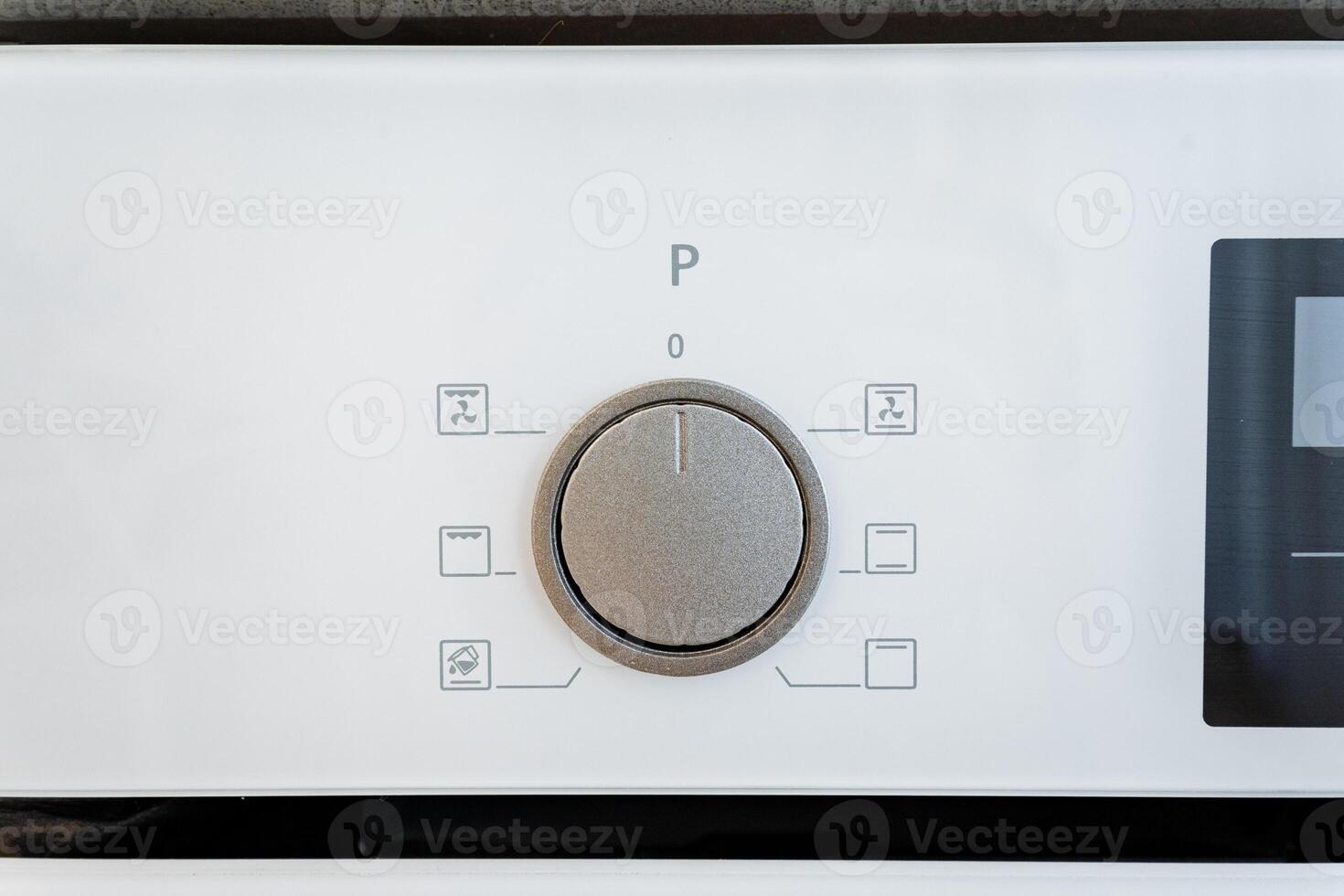 The white kitchen appliance control panel features userfriendly rotary dial settings for convenient cookware use, adding minimalist aesthetics and programmable options photo