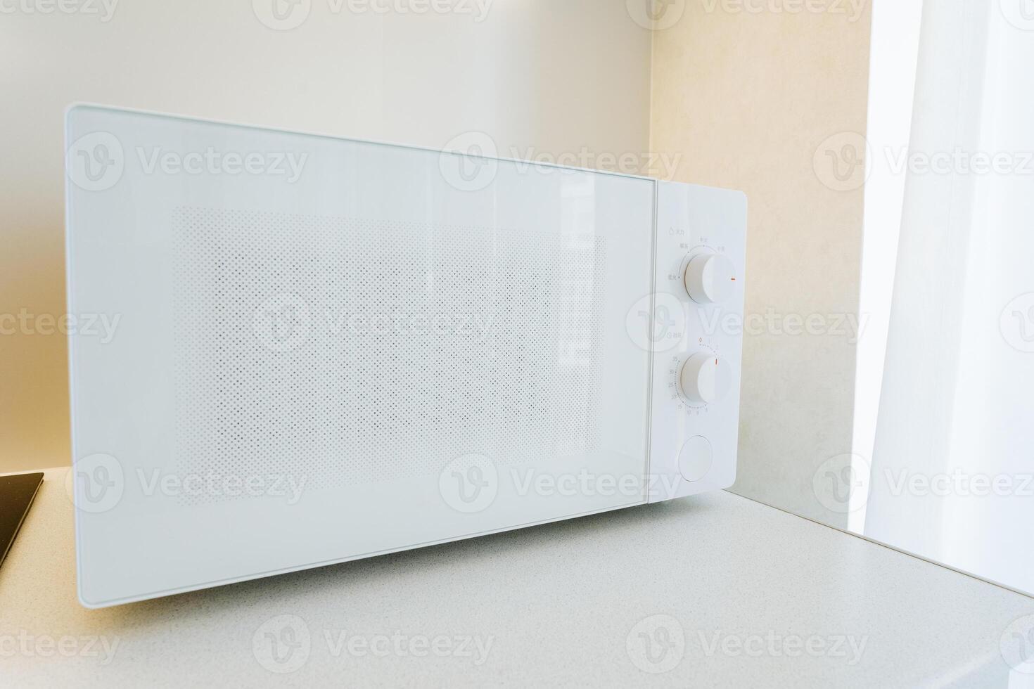 A minimalistic kitchen features a stylish white modern microwave oven, providing both elegance and convenience for cooking and heating food with efficiency and a touch of luxury photo
