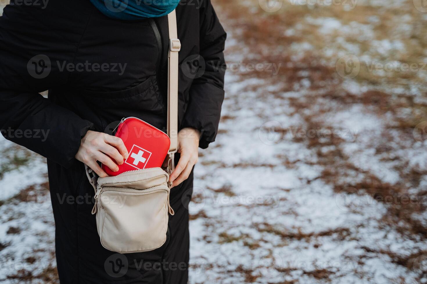 A woman is carrying an essential first aid kit conveniently placed in her purse, which she might need for any unexpected situations that arise while she is out and about photo