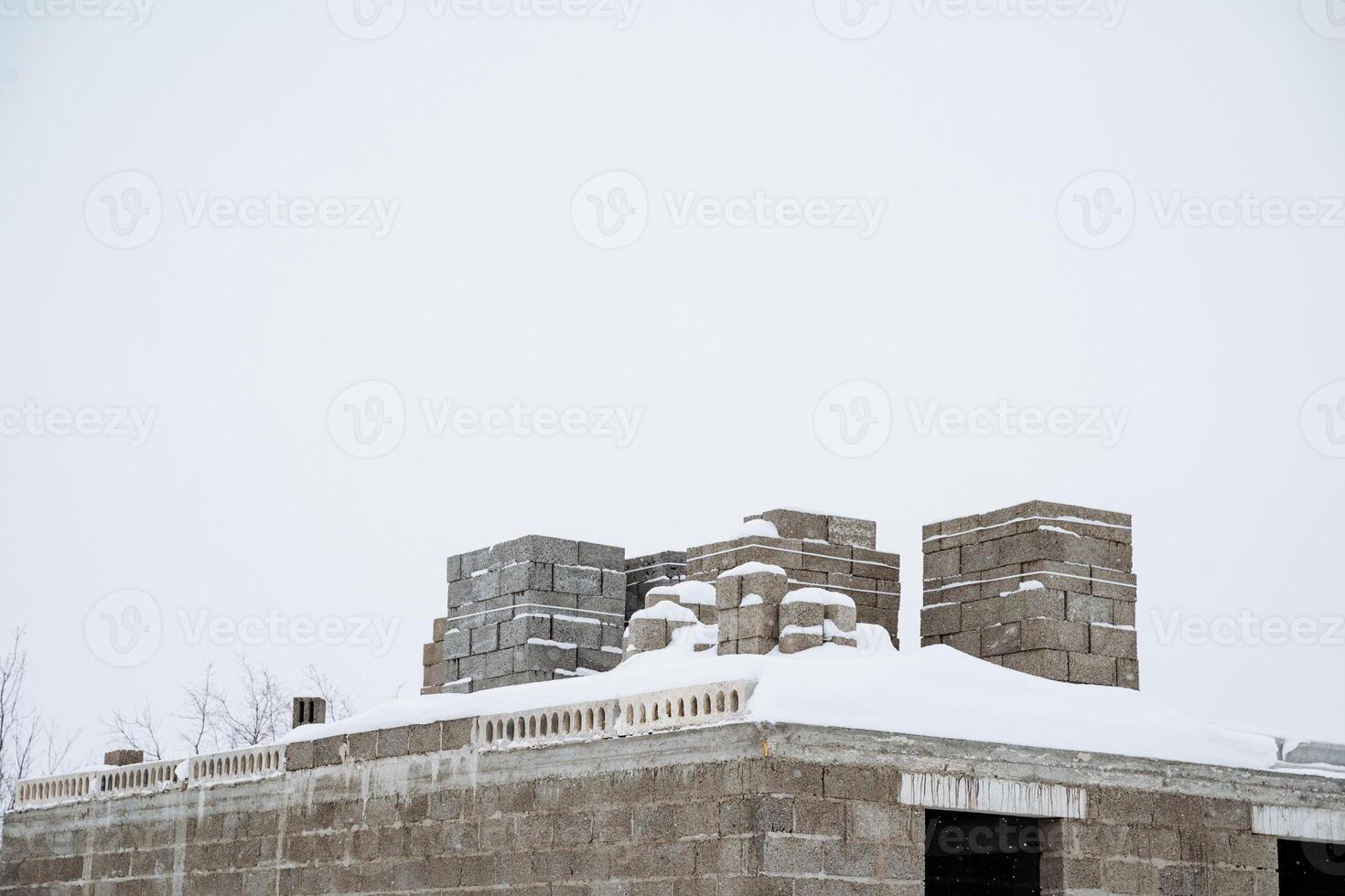 A building is currently under construction, and on its roof, there is a lovely soft layer of snow, adding a picturesque touch to the scene, especially in this winter weather photo