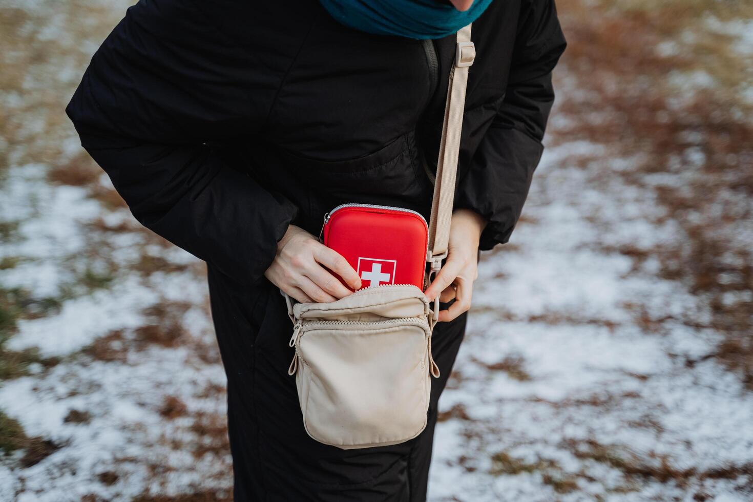 A woman keeps a compact first aid kit conveniently stored in her purse, ensuring that she is always prepared for any unexpected emergencies that may arise during her busy day out and about photo