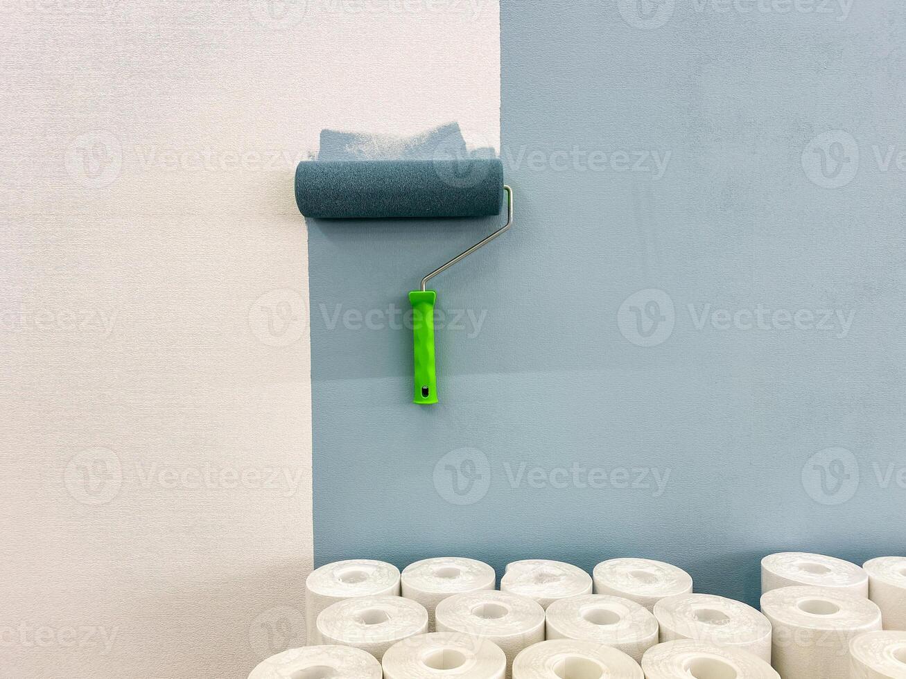 The painting process involves using a roller and necessary supplies, all set against a striking fresh blue wall background that enhances the overall aesthetic photo