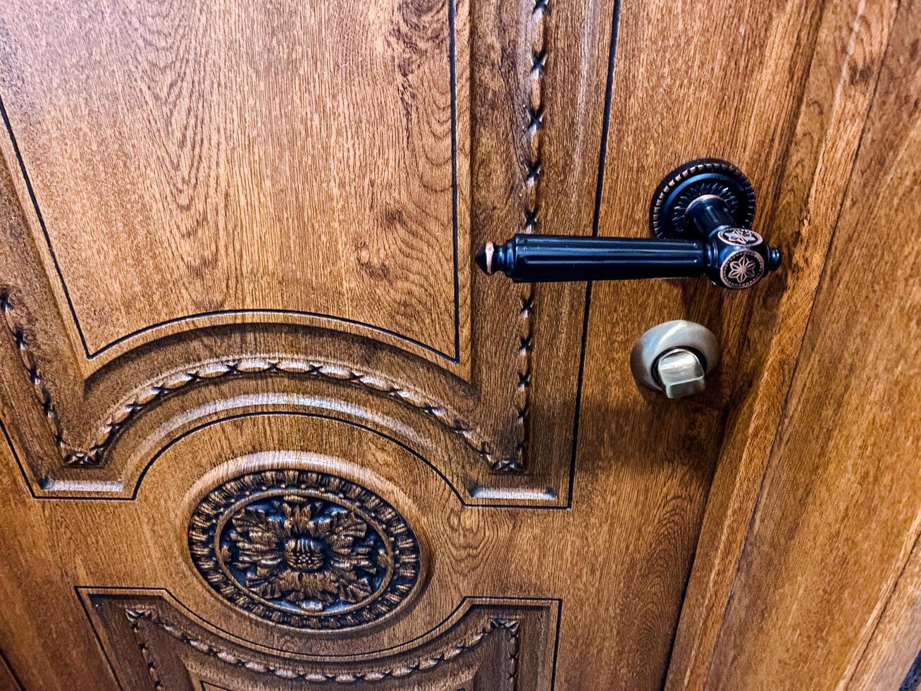 Elegantly Crafted Wooden Door Featuring Stunning Vintage Hardware, Offering a Timeless Look and Lasting Appeal photo
