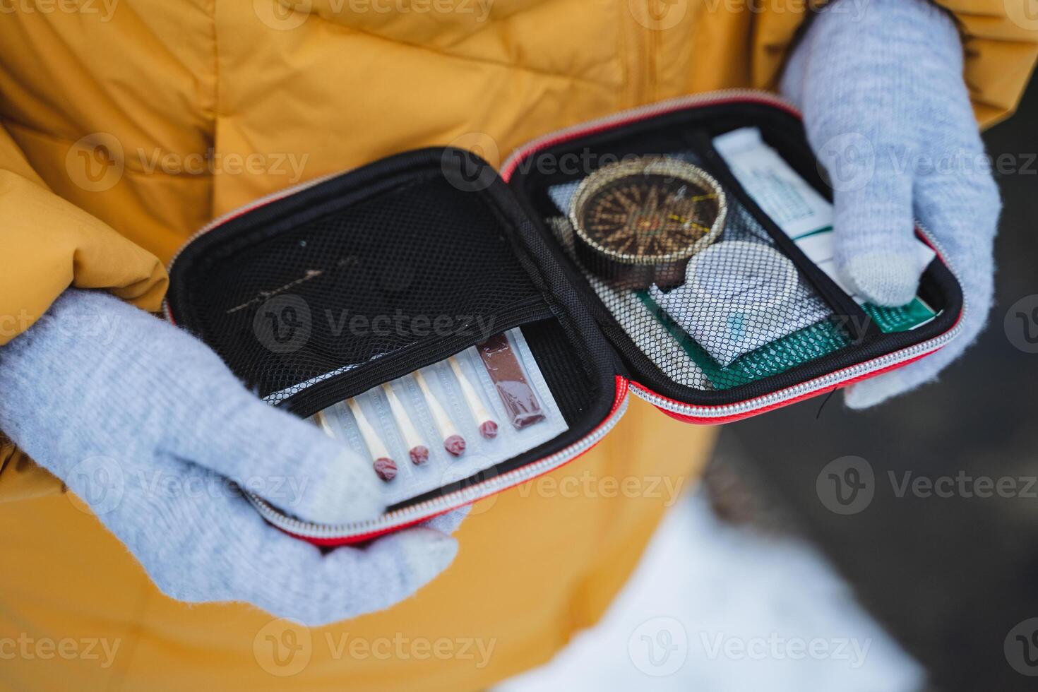 Essential Adventure Kit A collection of Survival Tools and a reliable Compass specifically designed for Outdoor Enthusiasts exploring in a snowy landscape and environment photo