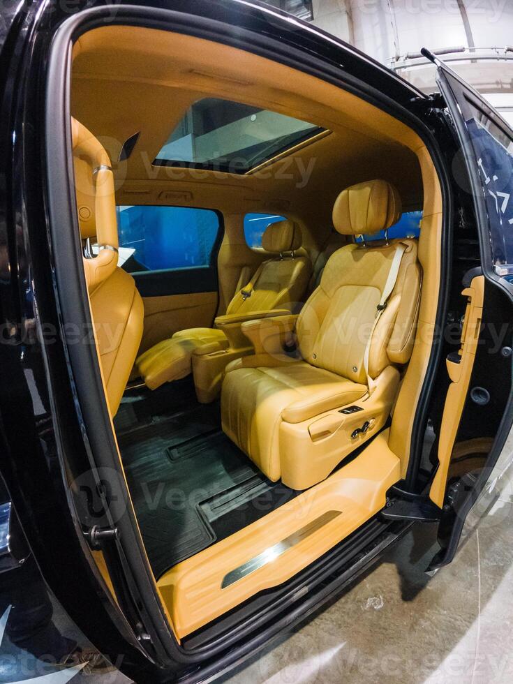 This stylish black car features vibrant yellow seats for color, complemented by an elegant sunroof that fills the interior with natural light, ensuring comfort on every drive photo
