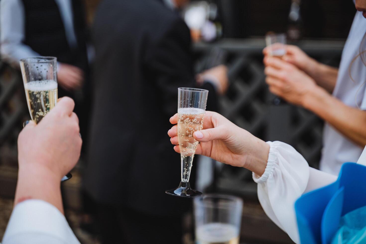 People raising champagne glasses in a toast at a special event photo