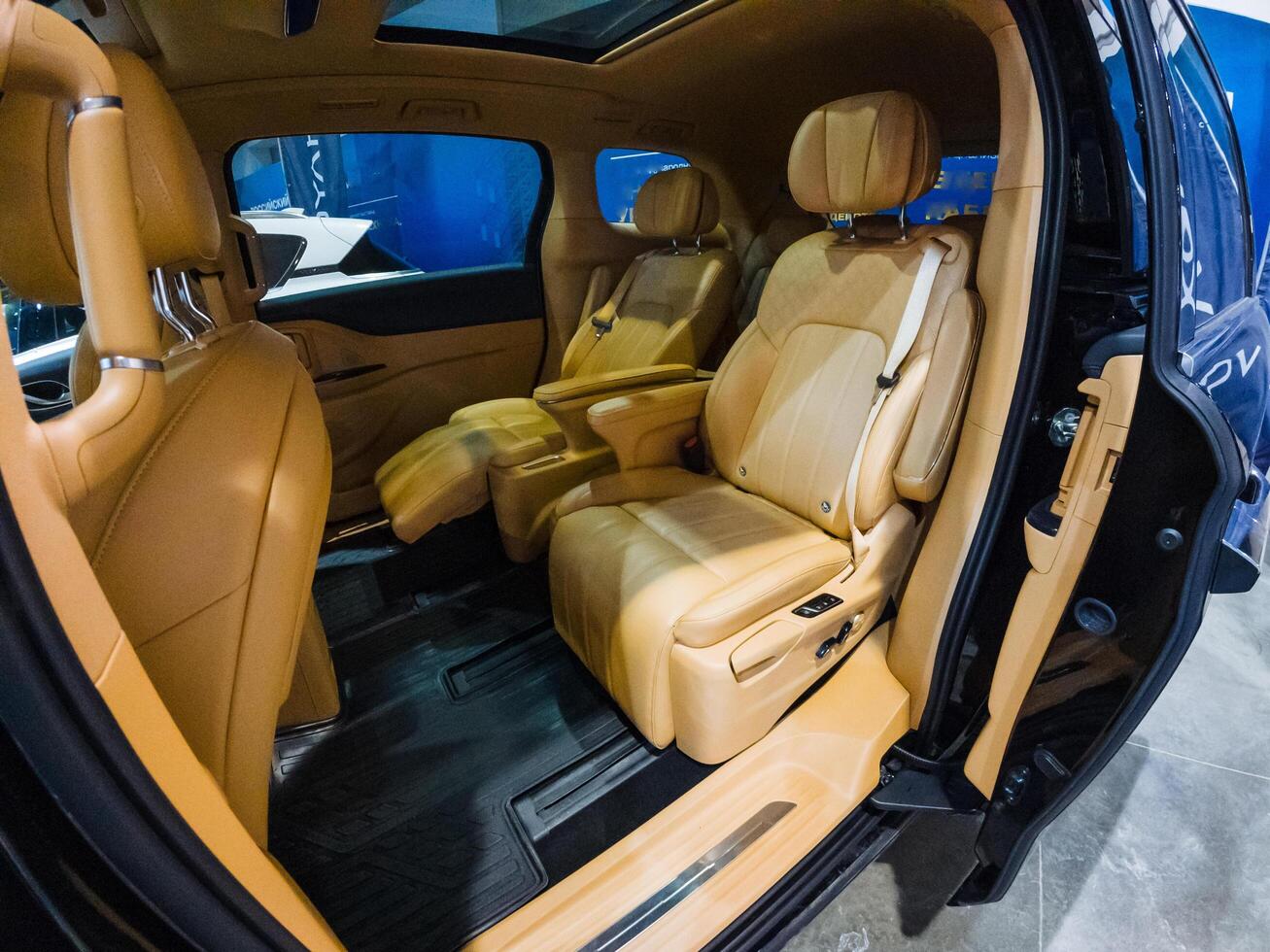 The interior space of a sleek black car is elegantly furnished with luxurious brown leather seats that exude comfort, style, and sophistication, making it a truly impressive vehicle photo