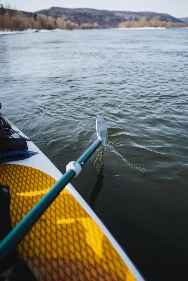paddle paddleboarding, paddle paddle in the water, yellow paddleboard, float on the water, hiking extreme hiking. photo