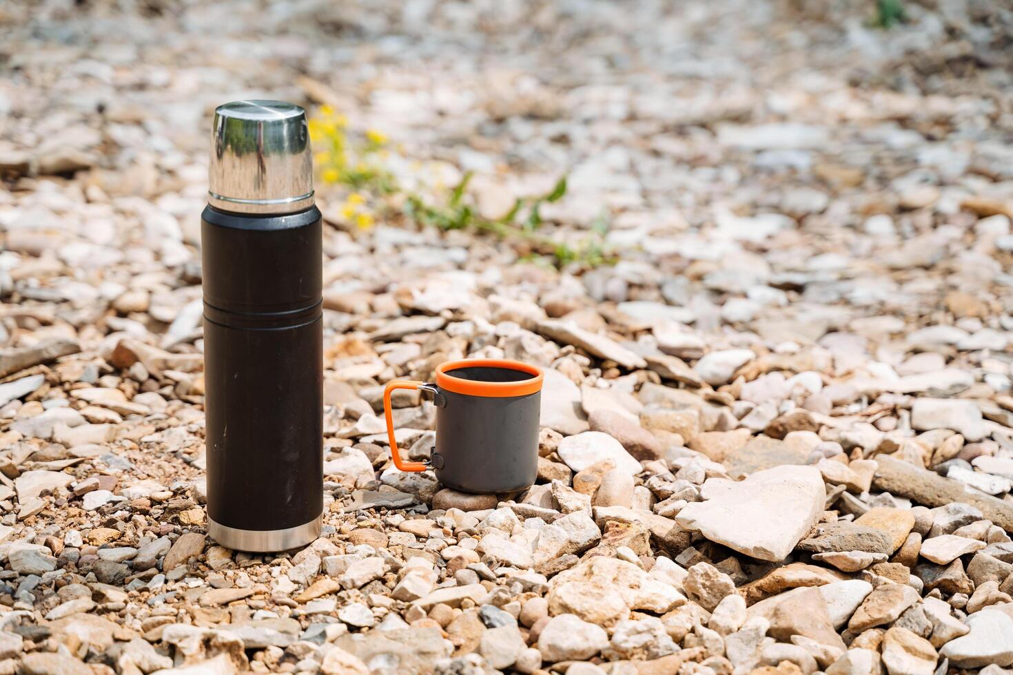 Prepare for outdoor adventures with a thermos and mug essential for hiking and camping on rugged terrain. Keep warm beverages handy to enjoy amidst the wilderness photo