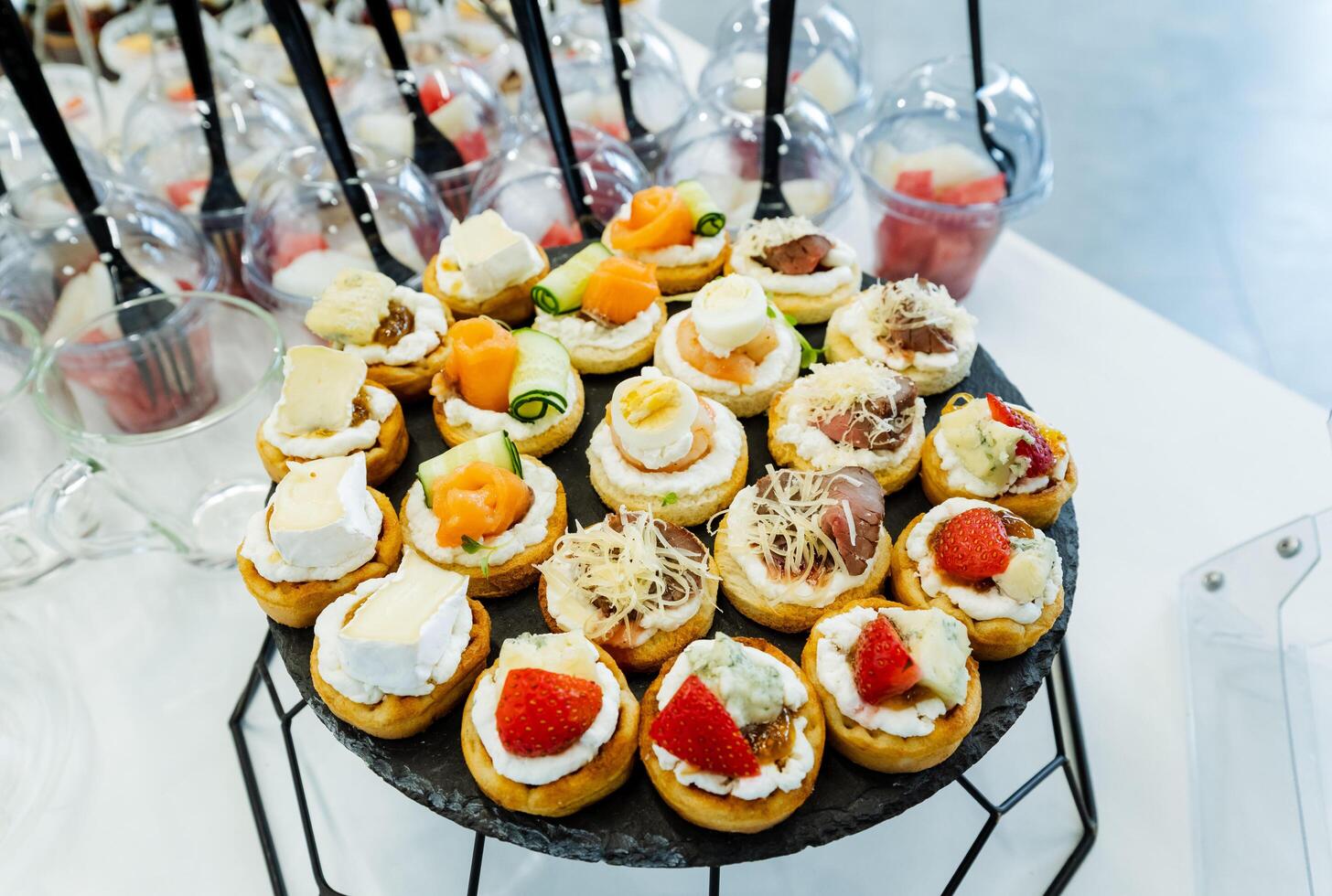 A stunning display of cupcakes with various toppings on a table at an event or party, enticing guests to indulge in the delicious treats and satisfy their sweet tooth cravings photo