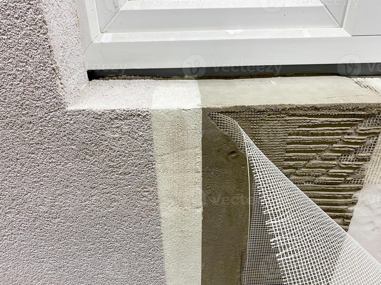 A detailed close up view of a window being meticulously installed into a wall, highlighting the intricate details of the materials used and the craftsmanship involved in the process photo