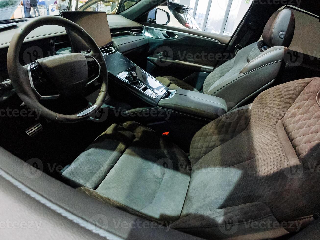 The interior of a car includes important features such as a steering wheel and seats, designed for comfort and ease of use, providing an essential space for passengers and drivers alike photo