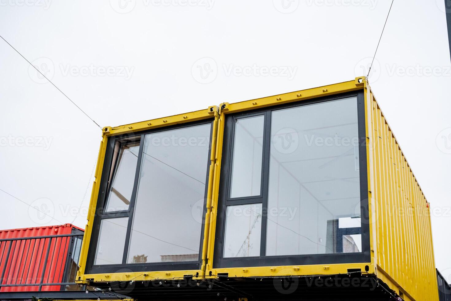 A yellow shipping container with a lot of windows photo