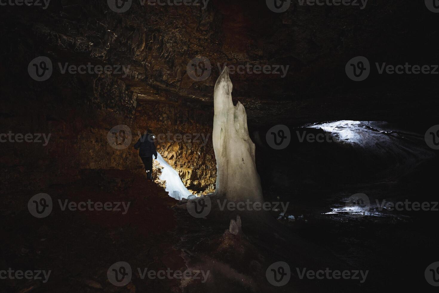 Embarking on an enthralling adventure into an icecovered cave reveals a mysterious journey filled with natures stunning ice sculptures photo