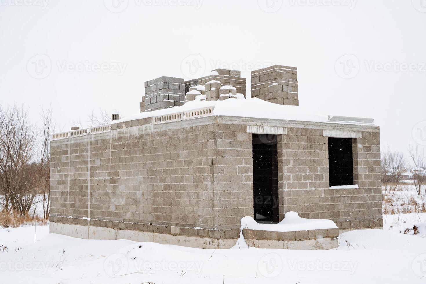 A beautiful winter scene depicts an abandoned concrete structure isolated in soft, untouched snow, creating a serene and pristine landscape that truly captivates the senses photo