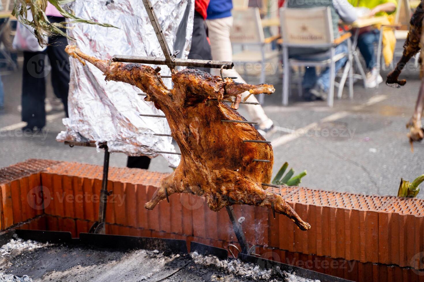 Experience the Traditional Roasting of Goat on a Stick at an exciting Outdoor Festival for food lovers photo