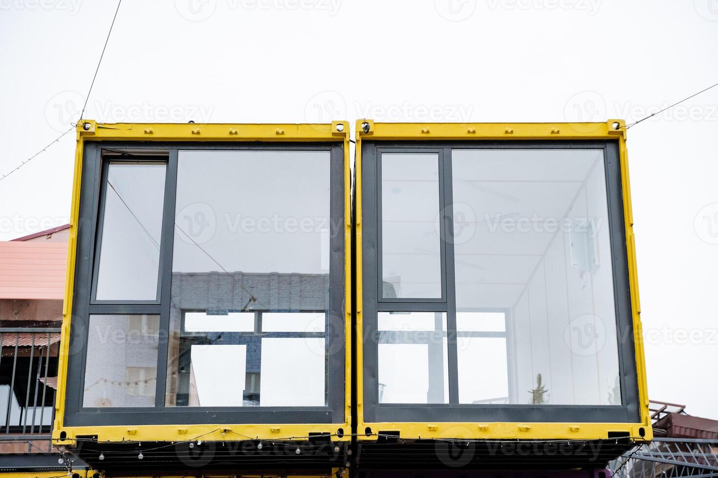 A vibrant yellow building with large, expansive windows is currently under construction, showcasing its impressive modern design and unique architectural features that stand out beautifully photo