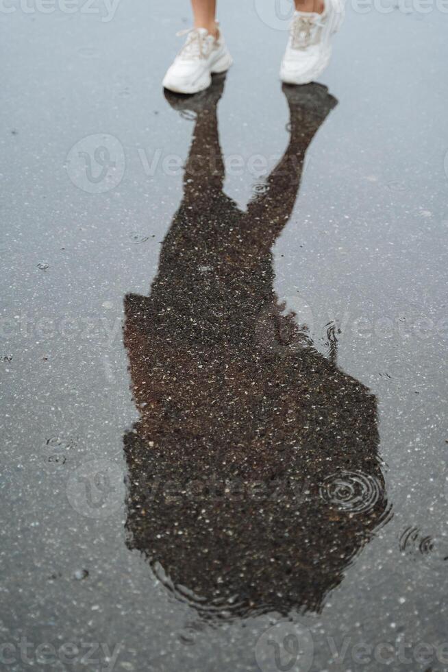 When a persons shadow falls on a pool of water, it creates a beautiful reflection, capturing the moment in a mesmerizing and captivating way that enchants the onlookers photo