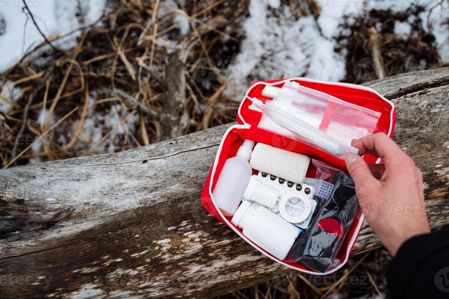 A prepared person confidently holds a stocked first aid kit, ready to assist anyone in urgent need during emergencies, highlighting the importance of being proactive and ready photo