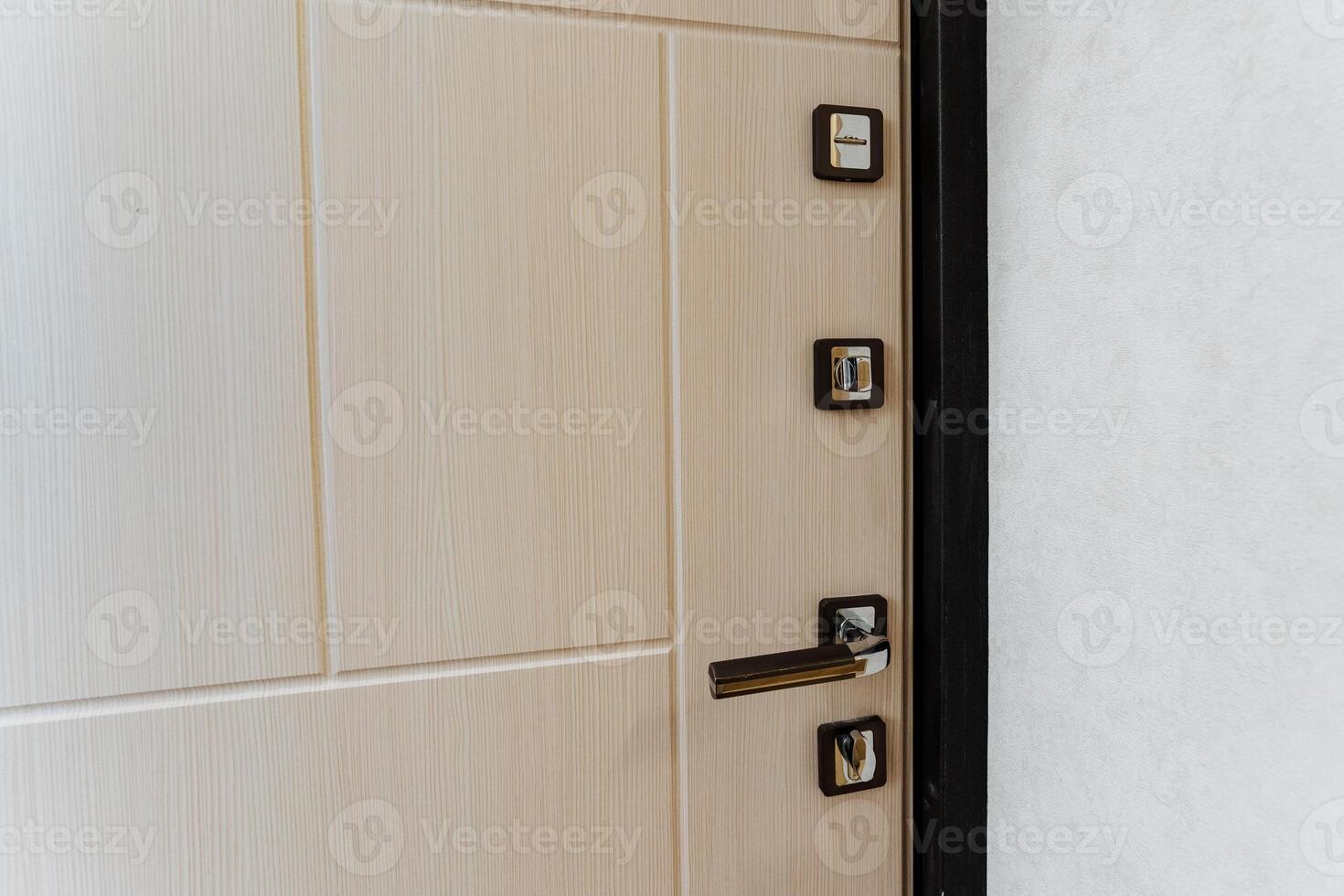 A detailed view of a door featuring a handle. The door is made of wood, possibly hardwood, with a rectangular shape. It appears to be a fixture on a cabinetry, possibly a home door photo