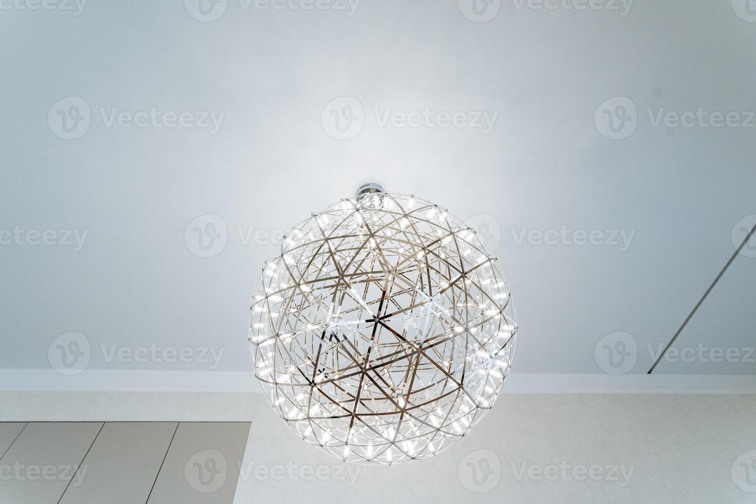 The room has a beautiful chandelier that enhances the cozy atmosphere with soft light, creating a welcoming ambiance. The elegant fixture adds art and elegance to the space photo