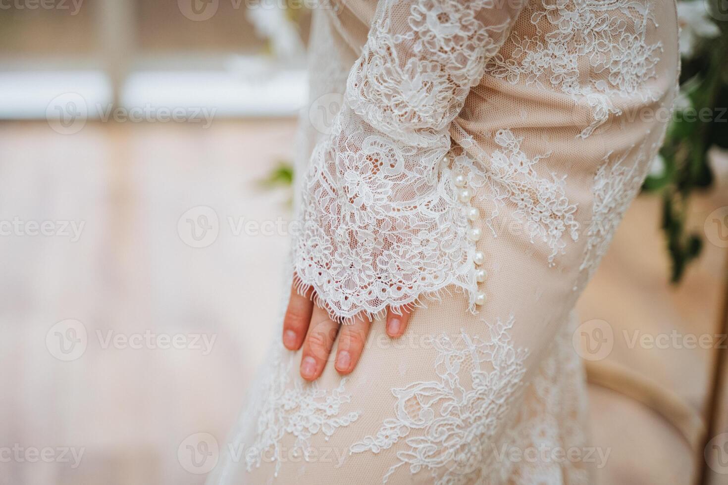 Bride in white lace gown with long sleeves at wedding ceremony photo