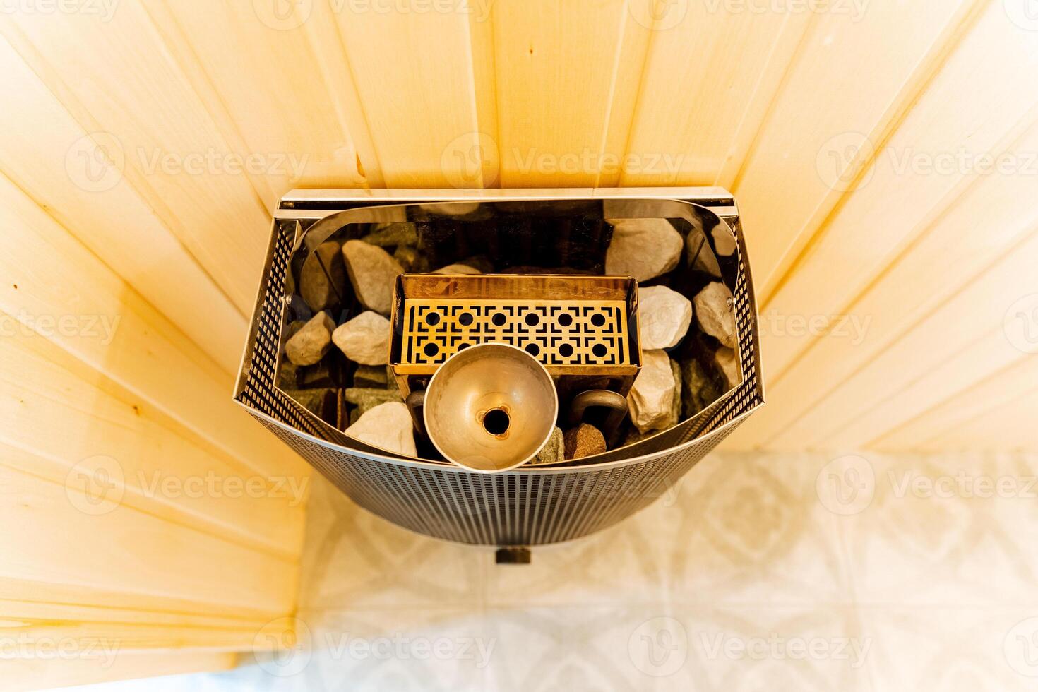 The photograph beautifully showcases the intricate textures and features of a sauna heater brimming with stones, offering a detailed closeup of its unique design and characteristics photo