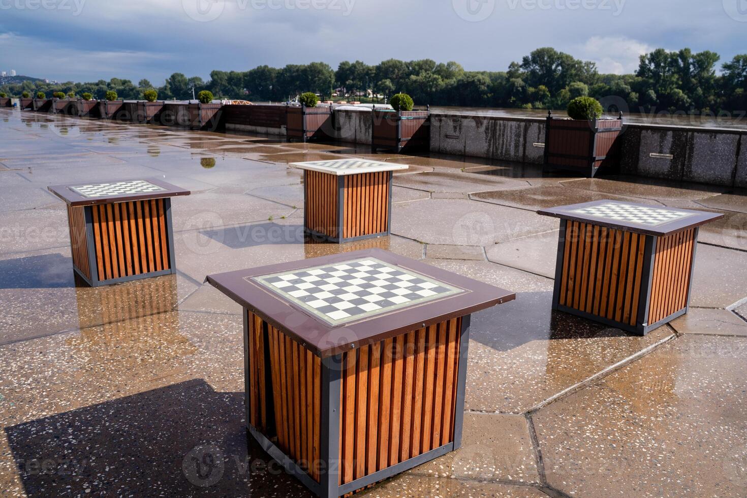 Enjoying Outdoor Chess Tables in a Park on a Rainy Day is an intriguing blend of nature and leisure pursuits photo