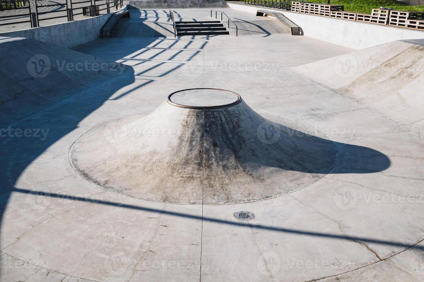 The Sunny Skatepark Bowl features beautifully Smooth Concrete and captivating Shadows, perfect for skaters and their thrilling rides photo