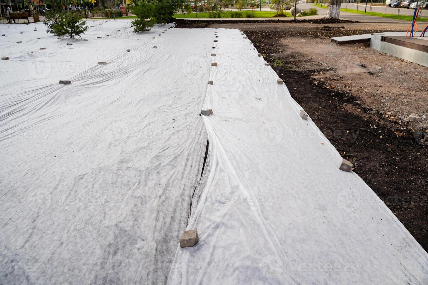 Preparing landscapes effectively involves using geotextile fabric, which serves as a method for weed control and prevention of erosion photo