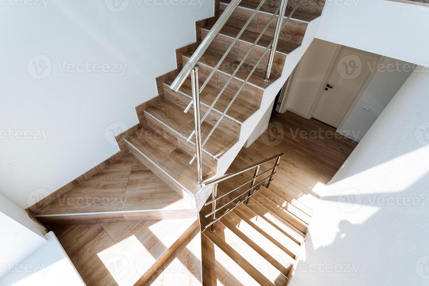 Featuring a modern wooden staircase with natural light and a sleek design, this interior space blends elegance and contemporary style with minimalist architectural details photo