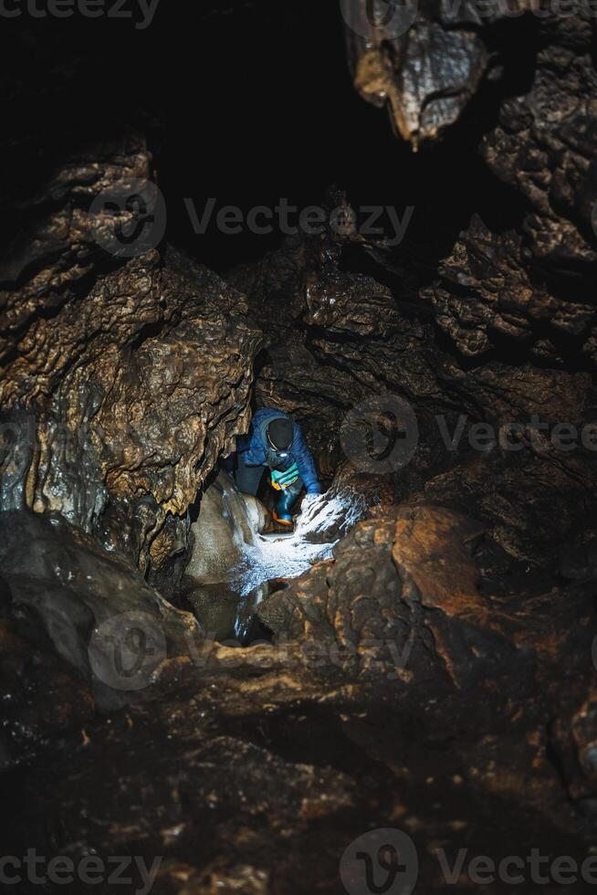 Immerse yourself in an adventurous caving exploration through a captivating and dark underground cave environment that awaits you photo