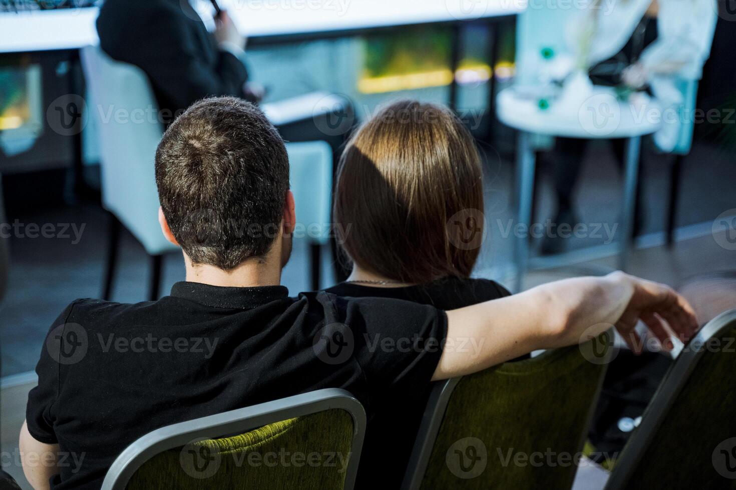 A man and a woman are embracing in chairs, showing affection photo