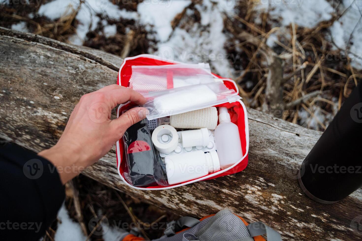 A person is confidently holding a first aid kit in their hand, ready to assist anyone in need of medical attention during an emergency or unexpected situation at any moment photo