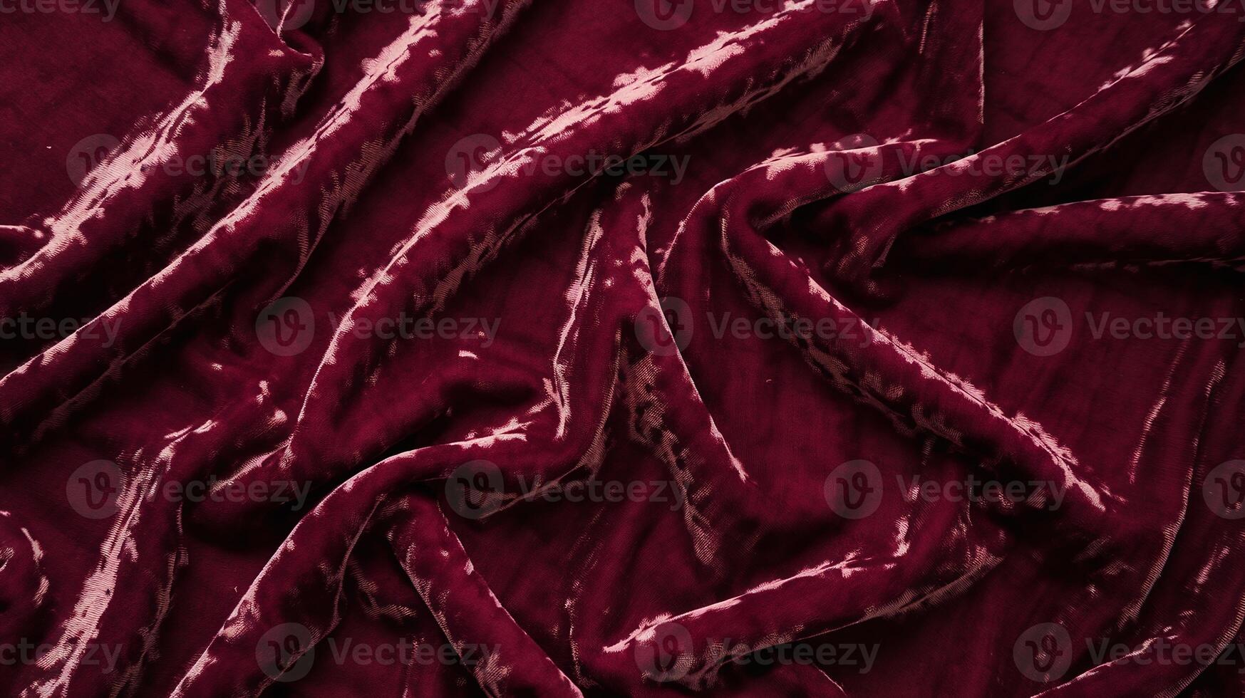 Rich Deep Red Velvet Fabric with Elegant Soft Texture and Crumpled Pattern on Dark Background photo