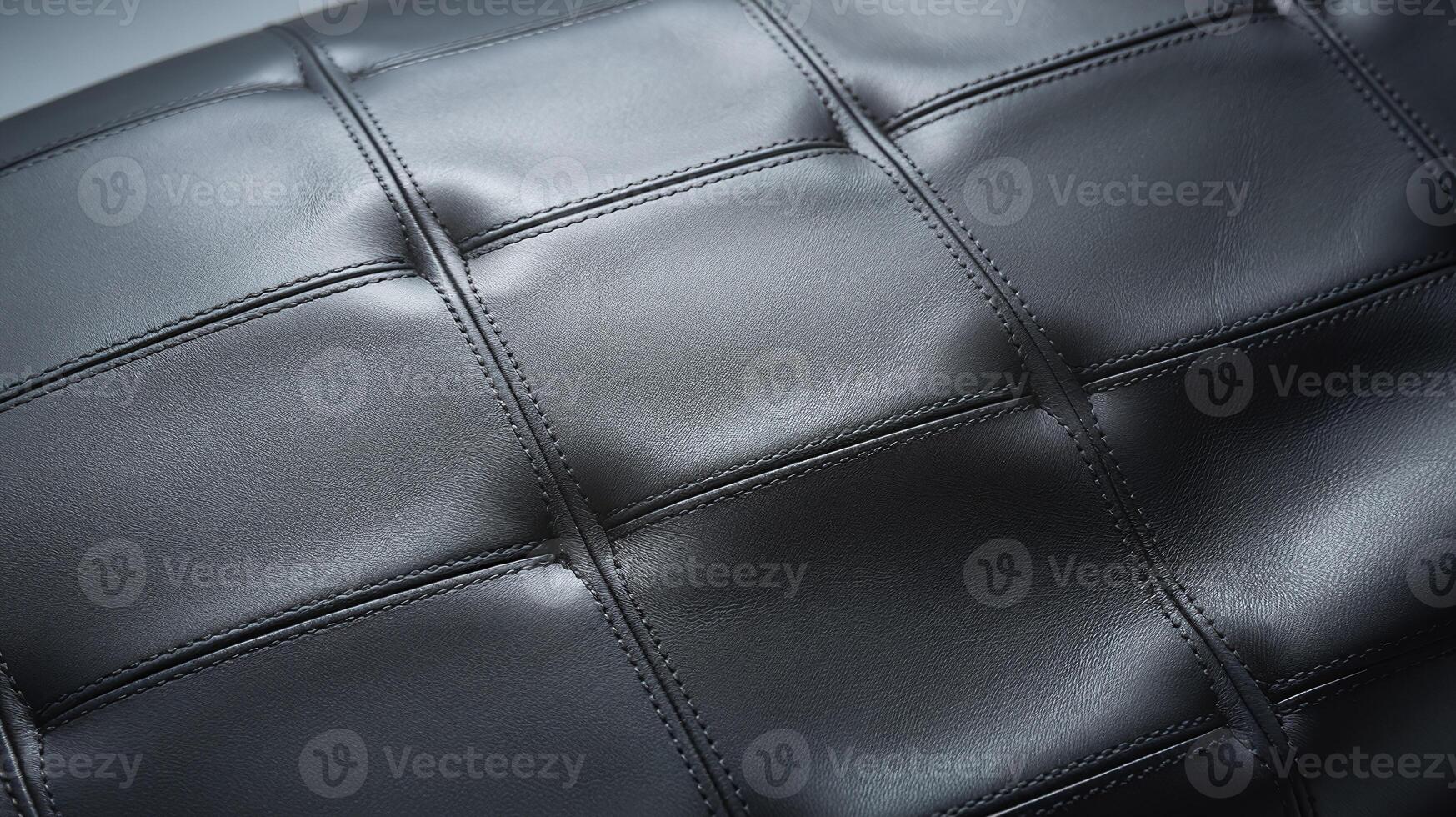 Close Up of Black Leather Upholstery with Detailed Stitching and Geometric Cushion Design photo