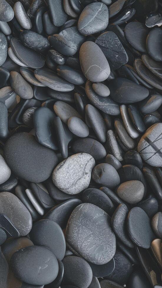Smooth Black and Gray Pebbles Overlapping in Natural Pattern with Subtle Texture Perfect for Zen or Spa Themes photo