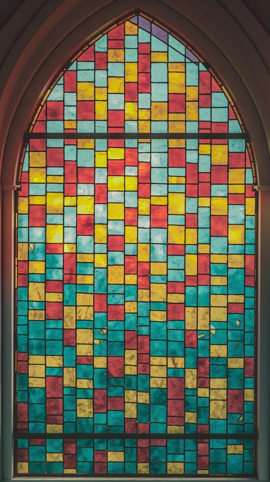 Vibrant Multicolored Stained Glass Window With Geometric Design In Gothic Arch Frame photo